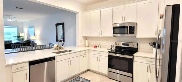 a kitchen with a sink stove and white cabinets
