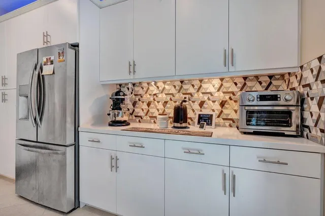 a kitchen with a sink and chairs