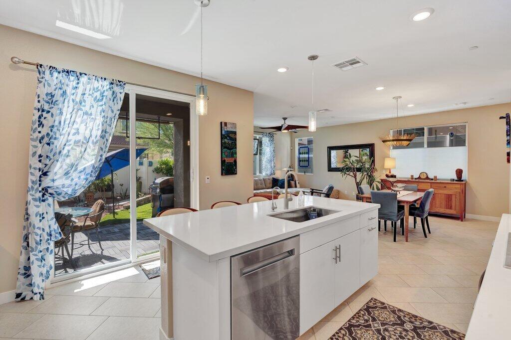 76345 Cornell Way Palm Desert, CA 92211 - Photo 13 of 47 a kitchen with a sink and chairs