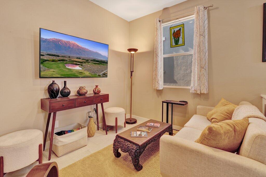 76345 Cornell Way Palm Desert, CA 92211 - Photo 14 of 47 a living room with furniture a rug and a wall painting