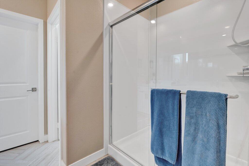 76345 Cornell Way Palm Desert, CA 92211 - Photo 20 of 47 a bathroom with a glass door shower a sink and a mirror