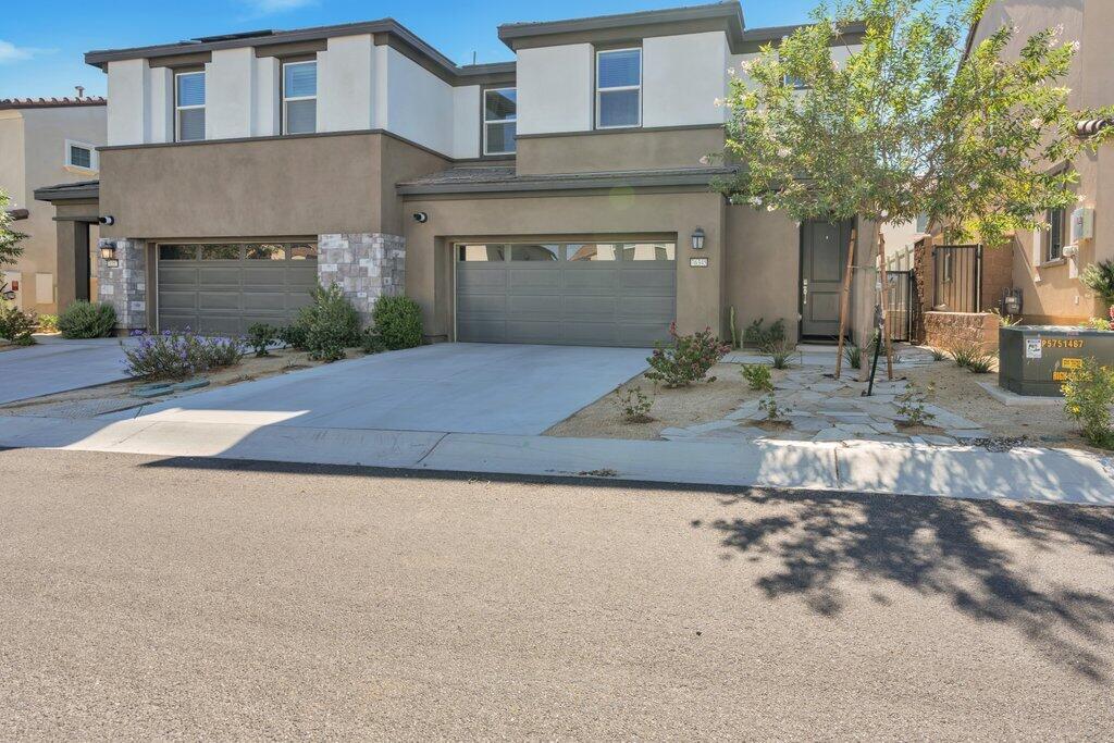 76345 Cornell Way Palm Desert, CA 92211 - Photo 2 of 47 a front view of a house with garden