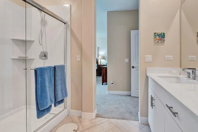 a bedroom with a bed and a painting on the wall