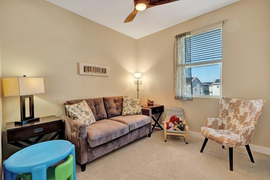 76345 Cornell Way Palm Desert, CA 92211 - Photo 25 of 47 a living room with furniture and a lamp