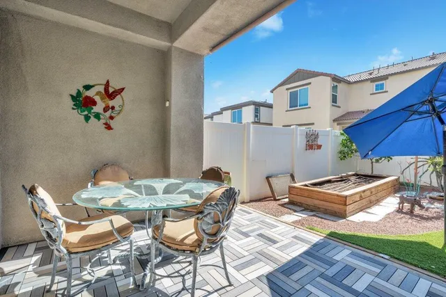 a view of backyard of house with outdoor seating and green space