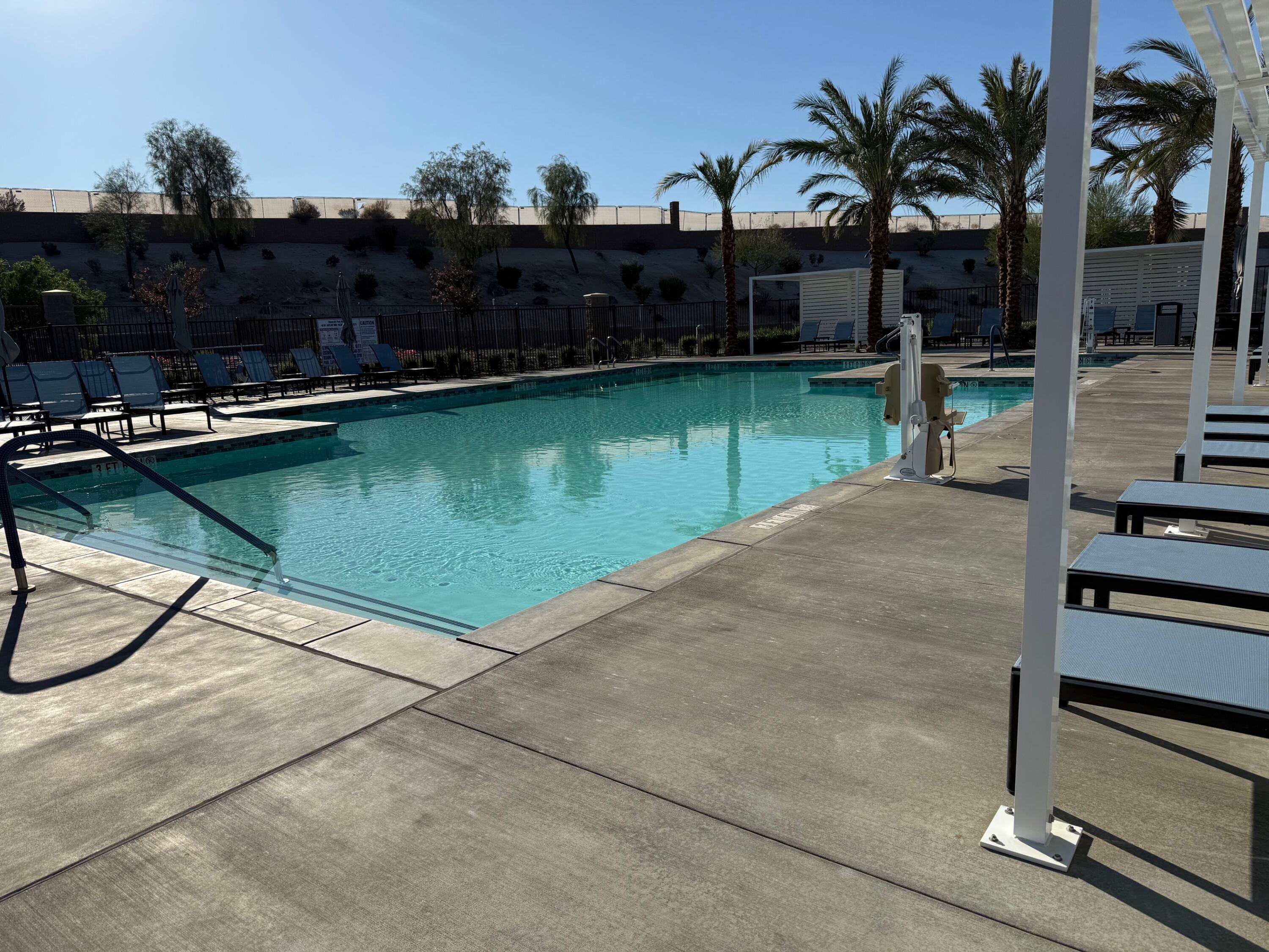 76345 Cornell Way Palm Desert, CA 92211 - Photo 43 of 47 a view of a swimming pool with a table and chairs