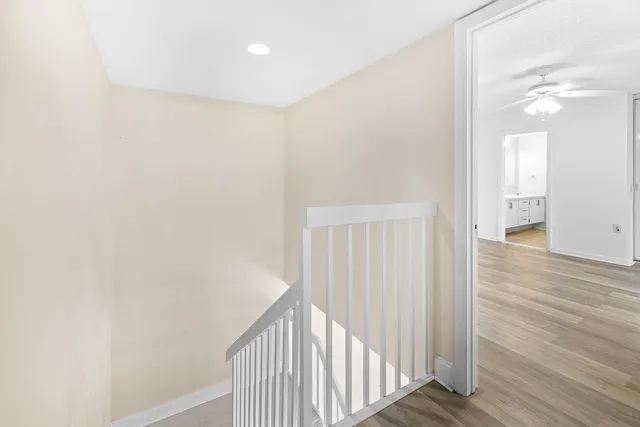 a view of a hallway with wooden floor