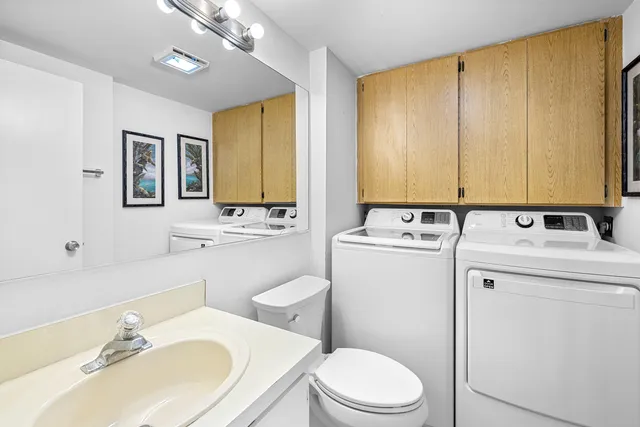 a bathroom with a sink a toilet and mirror