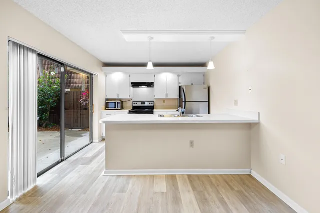 a view of kitchen with furniture and wooden floor