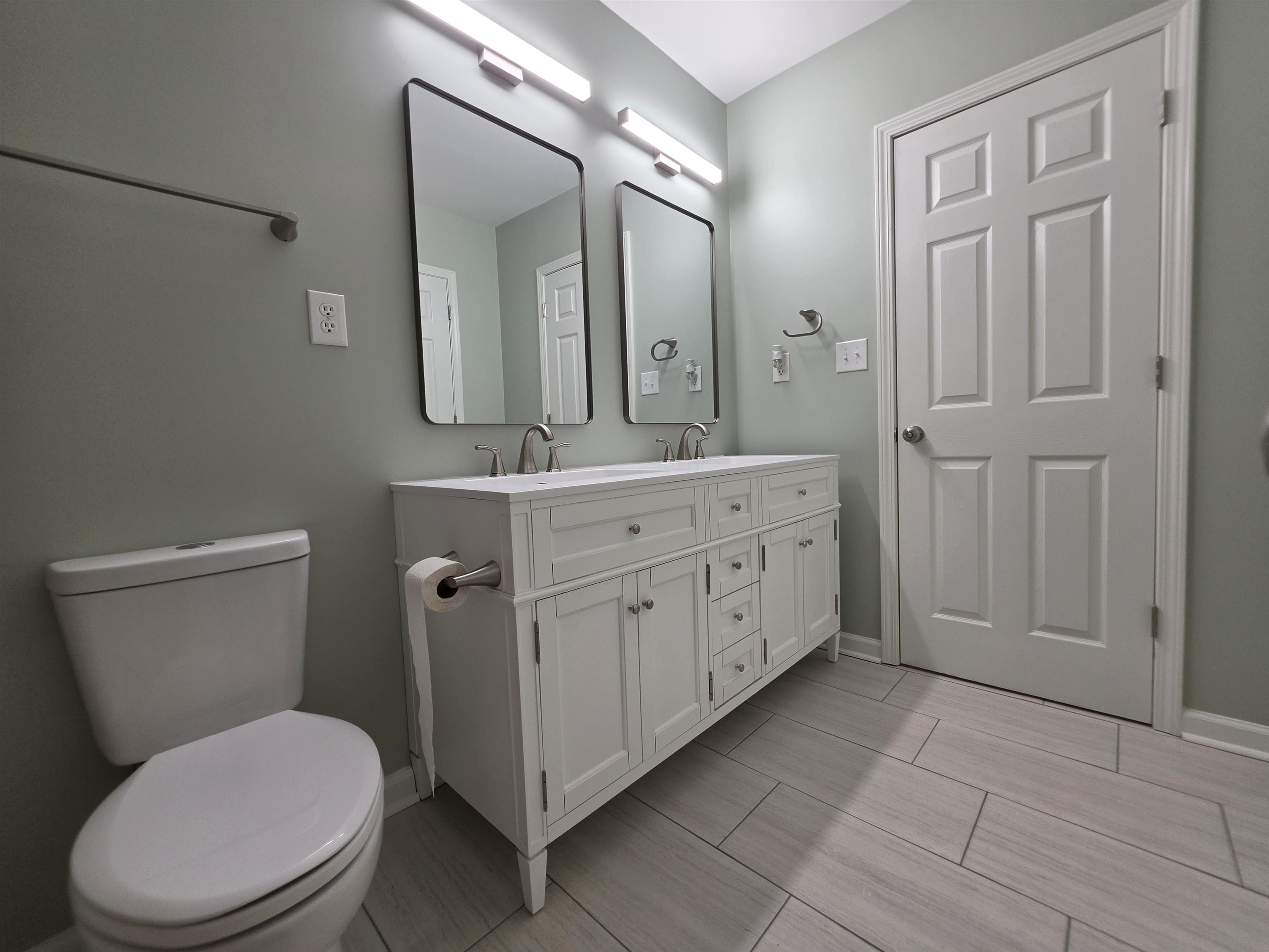 7966 Martha Road Millington, TN 38053 - Photo 16 of 26 Bathroom featuring a white double vanity with dual rectangular undermount sinks, contemporary faucets, and two framed wall-mounted mirrors