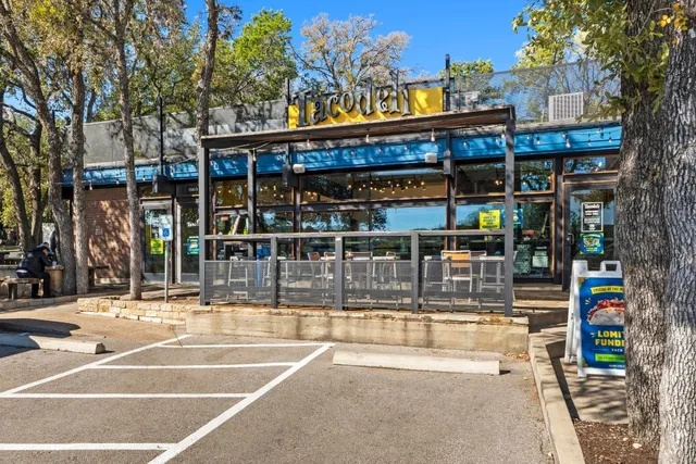 a front view of a house with a yard covered with snow