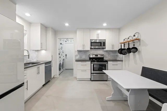 a kitchen with sink a microwave and refrigerator