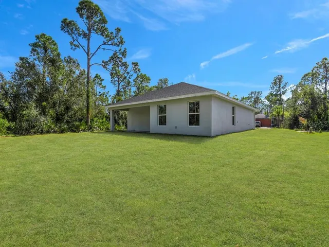 a view of a house with a backyard