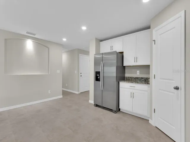 a kitchen with refrigerator a sink and cabinets