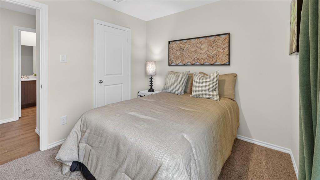 3514 Spring Time Street Terrell, TX 75126 - Photo 24 of 26 Carpeted bedroom featuring neutral wall tones, white trim, and a paneled door