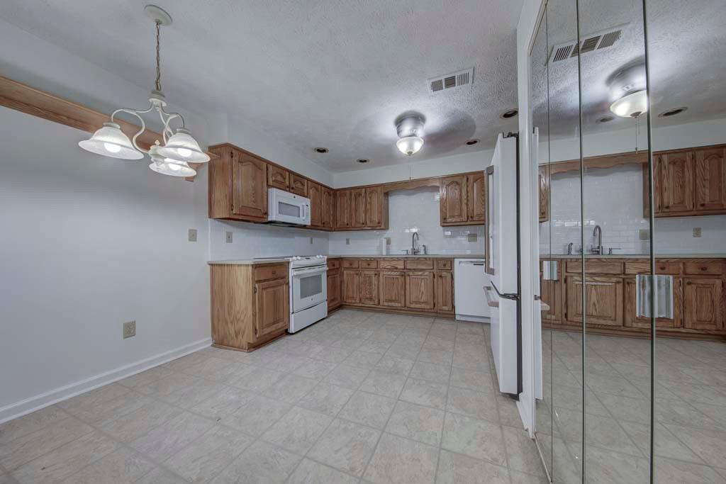 166 Maribeau Square Northwest Atlanta, GA 30327 - Photo 14 of 28 a view of a kitchen with a sink and microwave