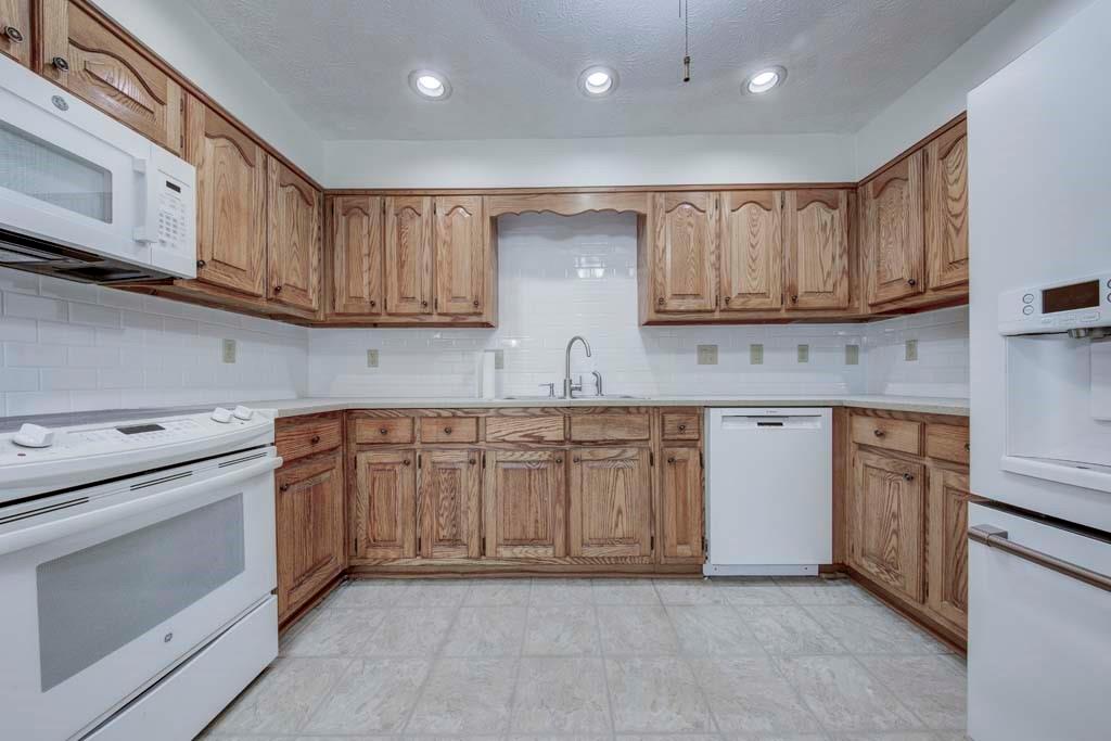 166 Maribeau Square Northwest Atlanta, GA 30327 - Photo 16 of 28 a kitchen with granite countertop cabinets stainless steel appliances and a sink