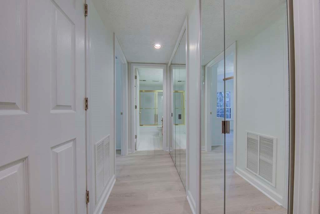 166 Maribeau Square Northwest Atlanta, GA 30327 - Photo 19 of 28 a view of a hallway with closet and bathroom