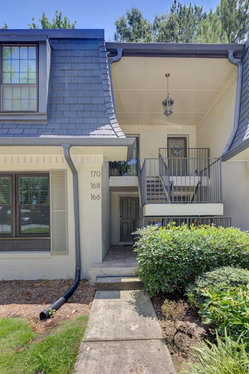 166 Maribeau Square Northwest Atlanta, GA 30327 - Photo 2 of 28 a front view of a house with garden