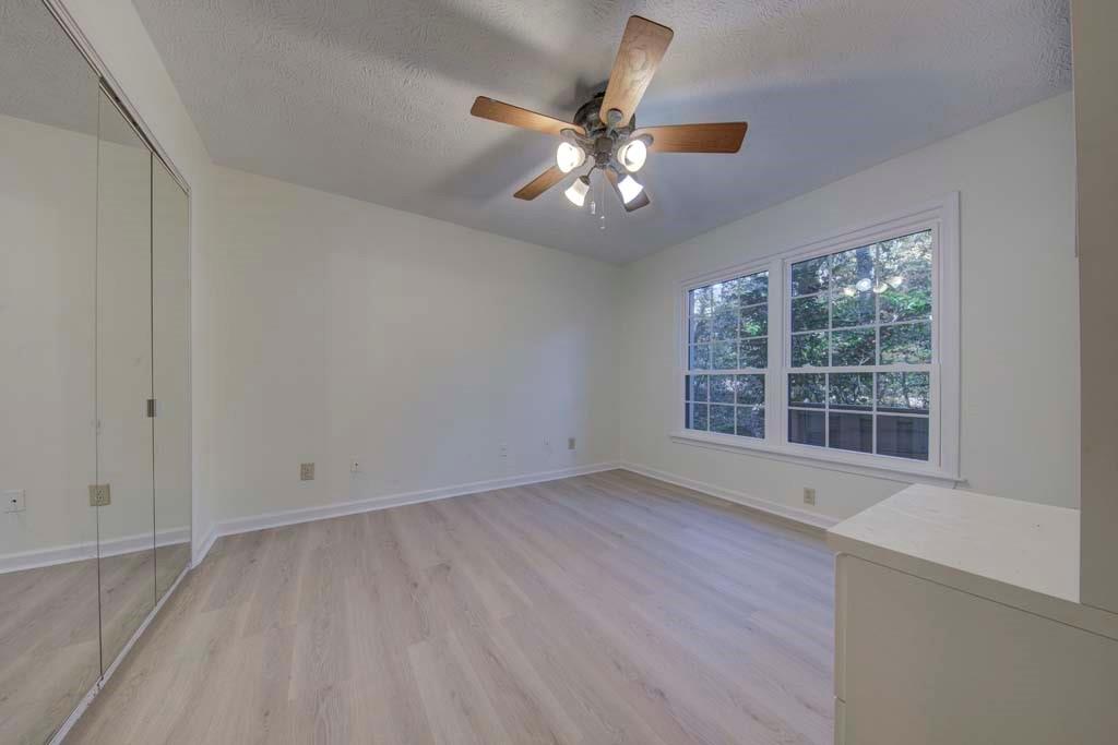 166 Maribeau Square Northwest Atlanta, GA 30327 - Photo 21 of 28 a view of an empty room with a window and wooden floor