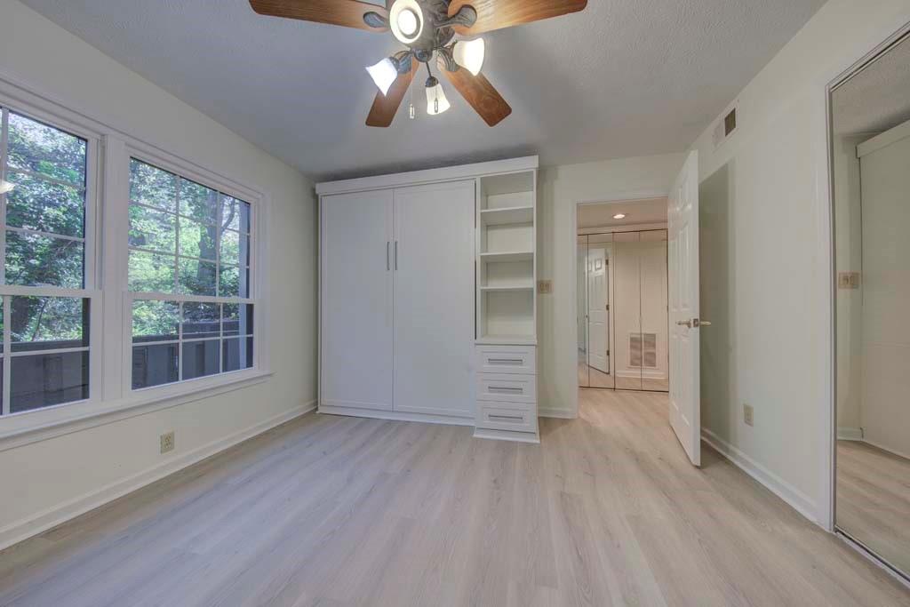 166 Maribeau Square Northwest Atlanta, GA 30327 - Photo 22 of 28 a view of empty room with wooden floor and fan