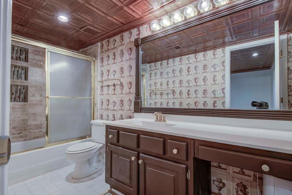 166 Maribeau Square Northwest Atlanta, GA 30327 - Photo 26 of 28 a bathroom with a granite countertop sink a toilet and shower