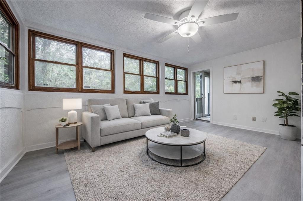 166 Maribeau Square Northwest Atlanta, GA 30327 - Photo 5 of 28 a living room with furniture and a large window