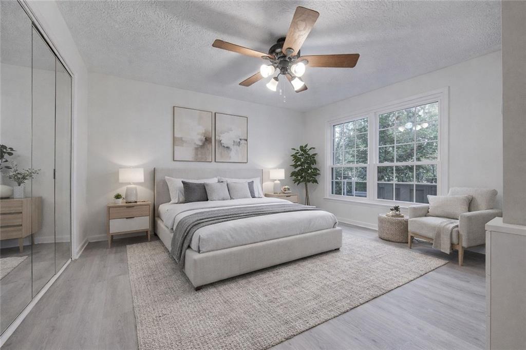 166 Maribeau Square Northwest Atlanta, GA 30327 - Photo 6 of 28 a bedroom with a large bed and furniture