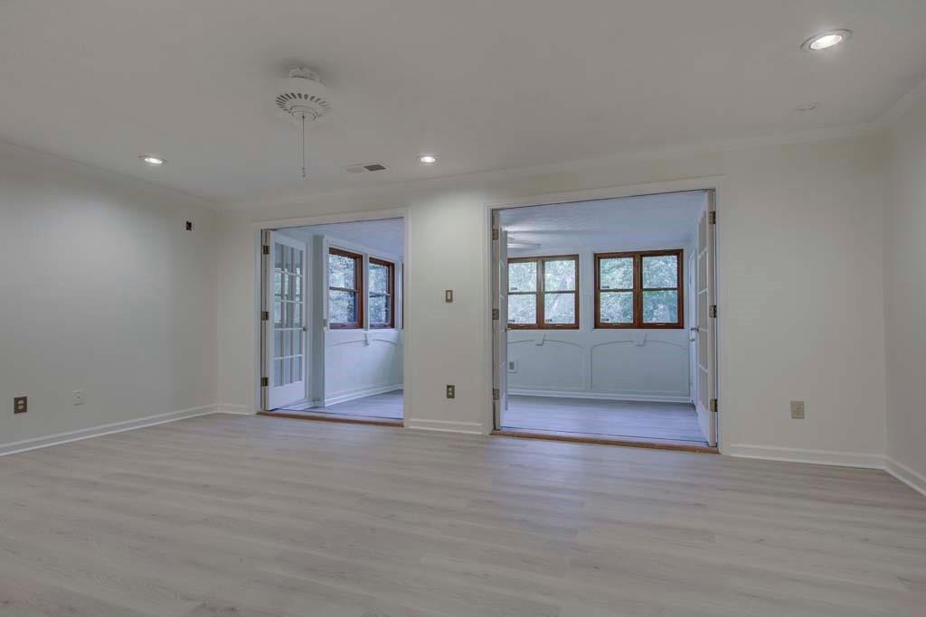 166 Maribeau Square Northwest Atlanta, GA 30327 - Photo 9 of 28 a view of an empty room with wooden floor and windows