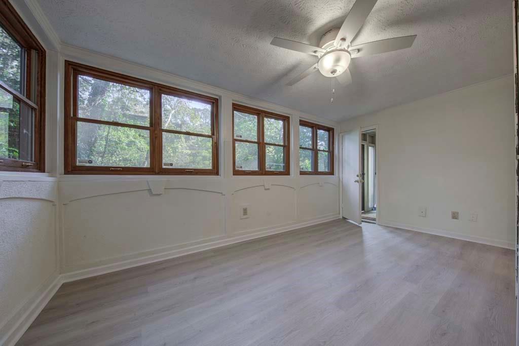 166 Maribeau Square Northwest Atlanta, GA 30327 - Photo 10 of 28 an empty room with wooden floor and windows
