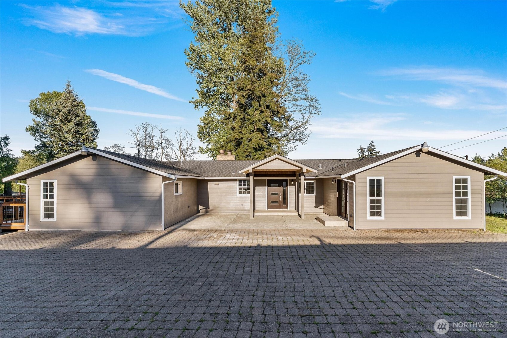 a front view of a house with a garden