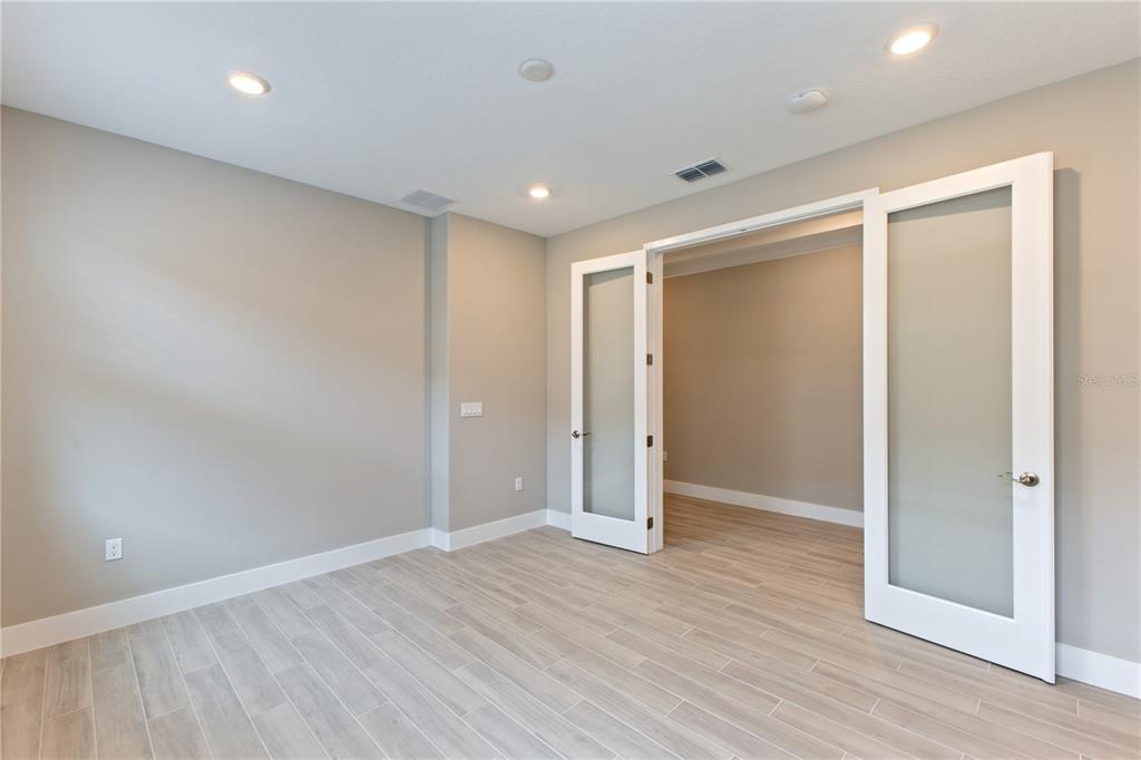 4516 Northwest 54th Terrace Ocala, FL 34482 - Photo 12 of 25 an empty room with wooden floor and closet area