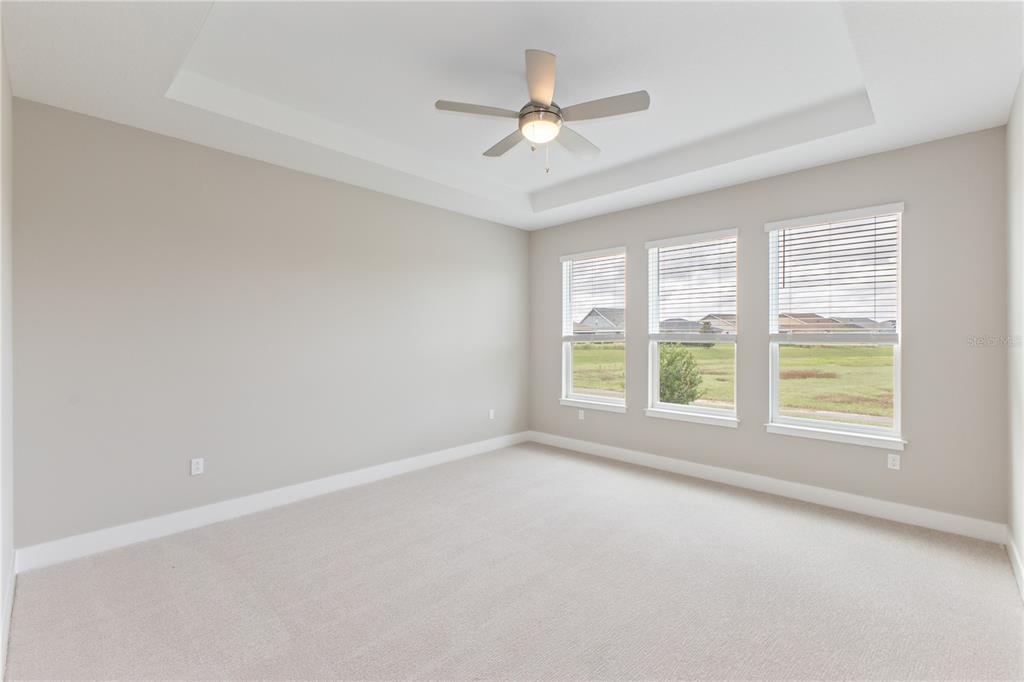 4516 Northwest 54th Terrace Ocala, FL 34482 - Photo 14 of 25 an empty room with a window and a ceiling fan