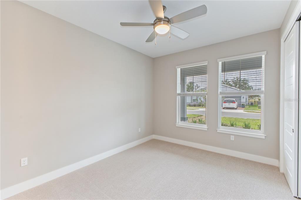 4516 Northwest 54th Terrace Ocala, FL 34482 - Photo 20 of 25 an empty room with a window and a fan
