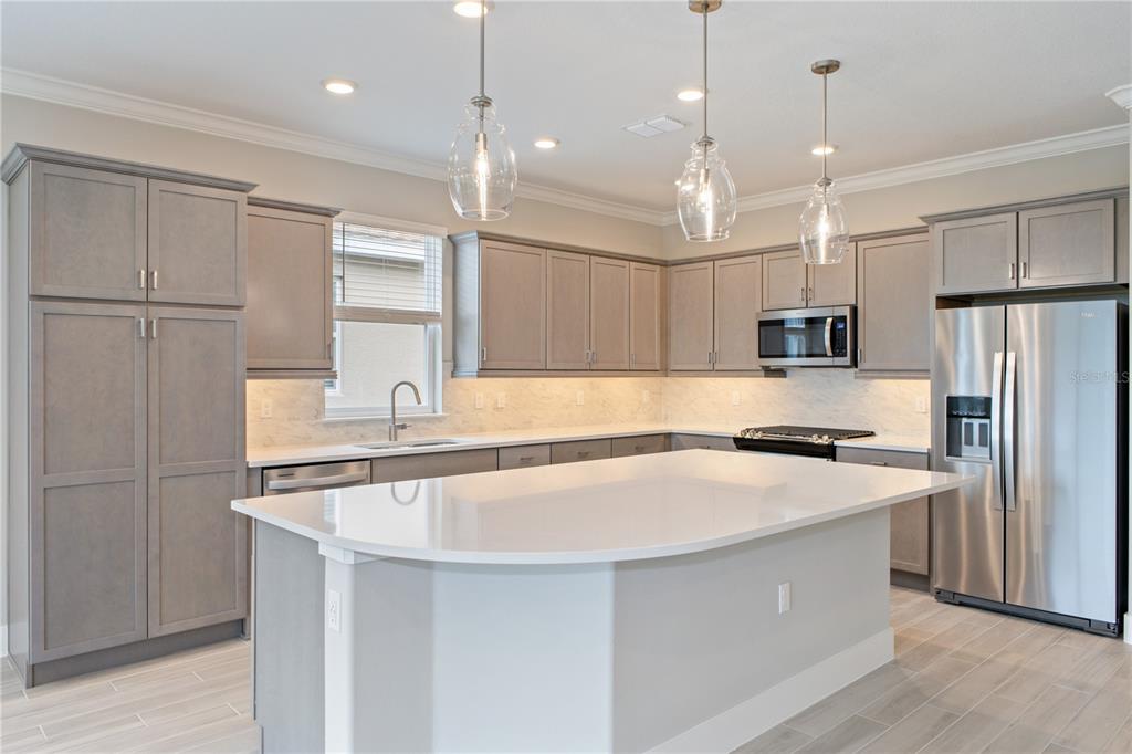 4516 Northwest 54th Terrace Ocala, FL 34482 - Photo 2 of 25 a kitchen with kitchen island a sink stainless steel appliances and cabinets