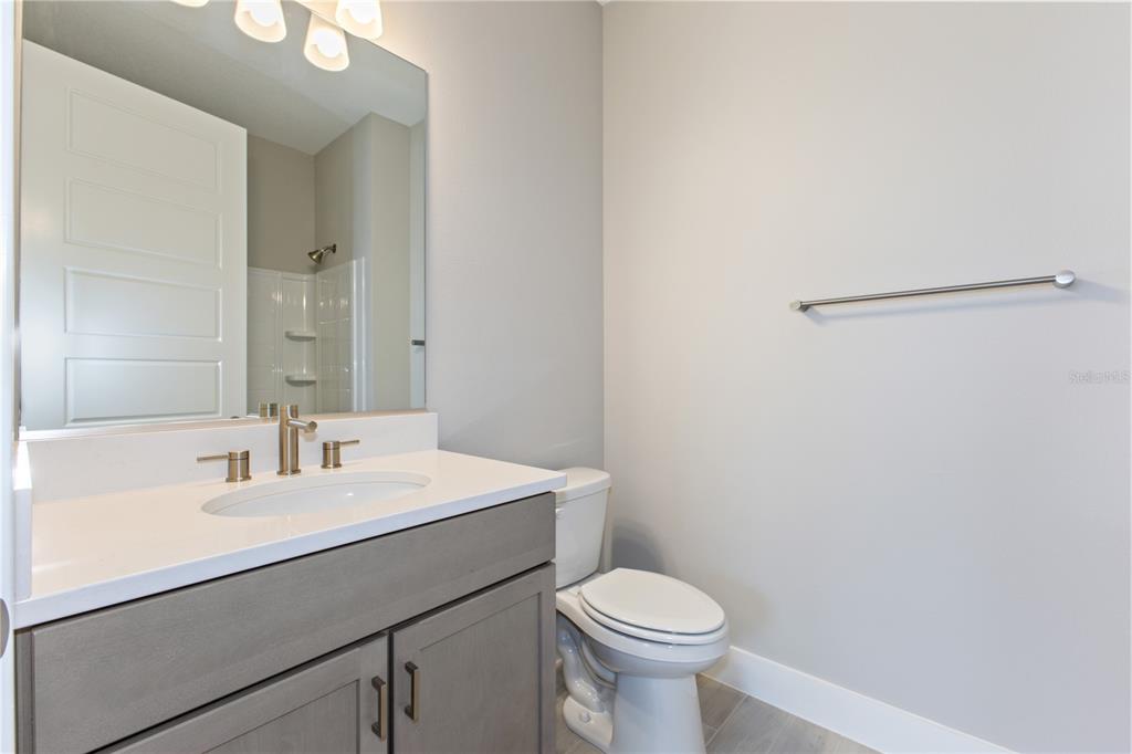 4516 Northwest 54th Terrace Ocala, FL 34482 - Photo 22 of 25 a bathroom with a sink a toilet and mirror