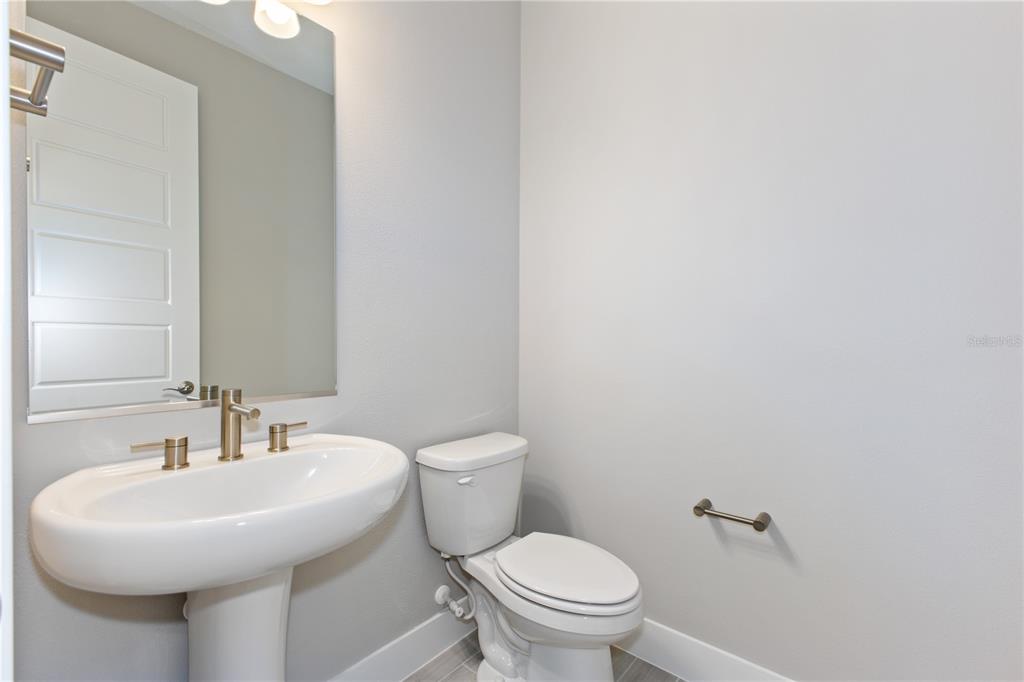 4516 Northwest 54th Terrace Ocala, FL 34482 - Photo 23 of 25 a bathroom with a sink a toilet and a mirror