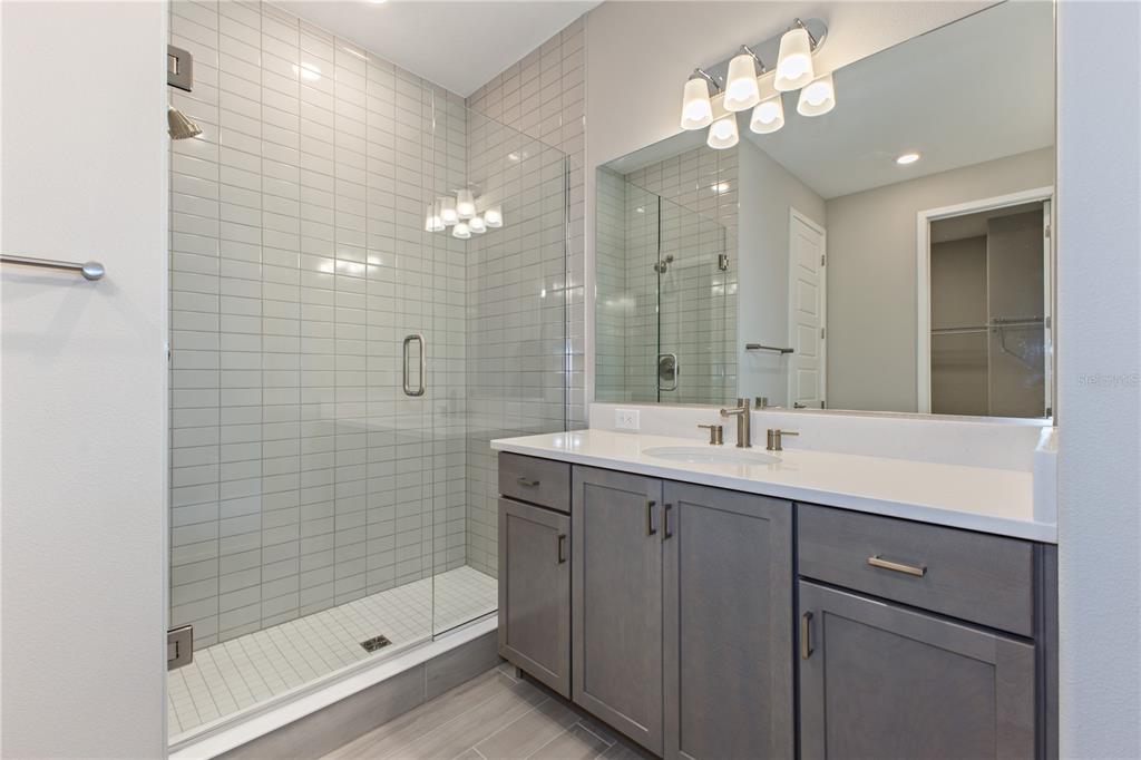 4516 Northwest 54th Terrace Ocala, FL 34482 - Photo 23 of 32 a bathroom with a double vanity sink mirror and shower