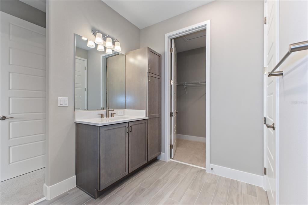 4516 Northwest 54th Terrace Ocala, FL 34482 - Photo 25 of 32 a bathroom with a double vanity sink and a mirror