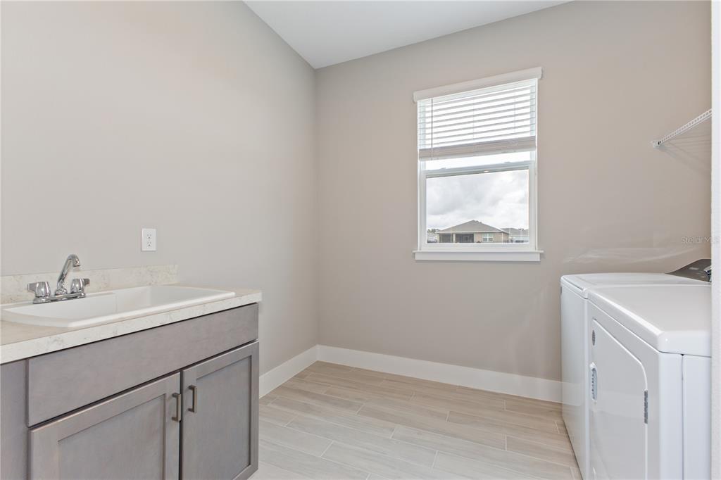 4516 Northwest 54th Terrace Ocala, FL 34482 - Photo 30 of 32 a bathroom with a sink a vanity and a window