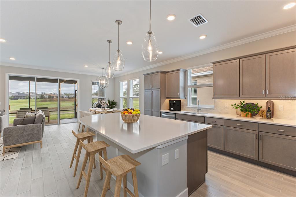 4516 Northwest 54th Terrace Ocala, FL 34482 - Photo 8 of 32 a kitchen with a dining table chairs and white cabinets