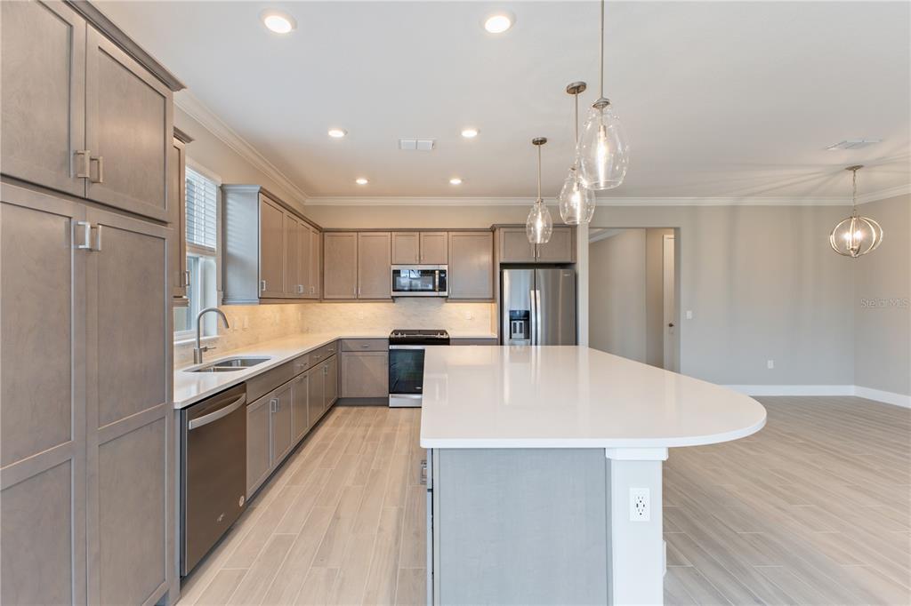 4516 Northwest 54th Terrace Ocala, FL 34482 - Photo 10 of 32 a large kitchen with a table and chairs