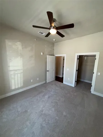 a view of a livingroom with a ceiling fan and window