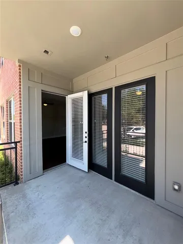 a view of an empty room with glass door