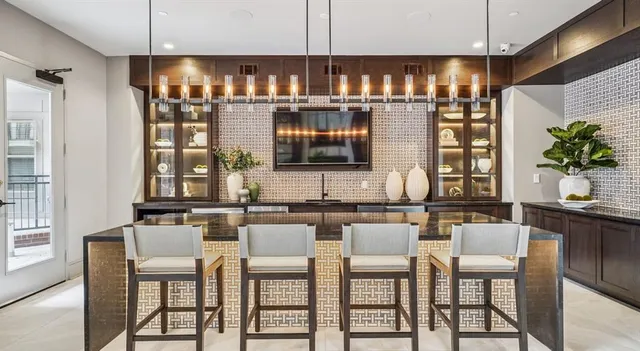 a kitchen with a table chairs and white cabinets