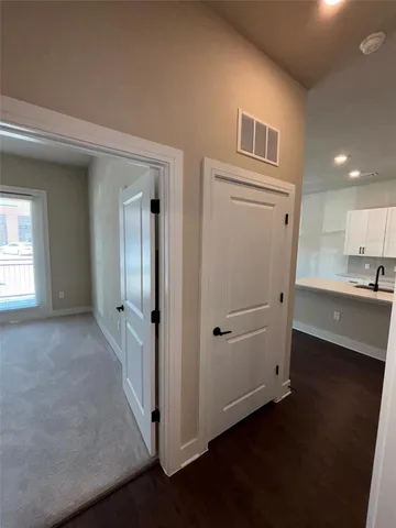 wooden floor in an empty room and a kitchen