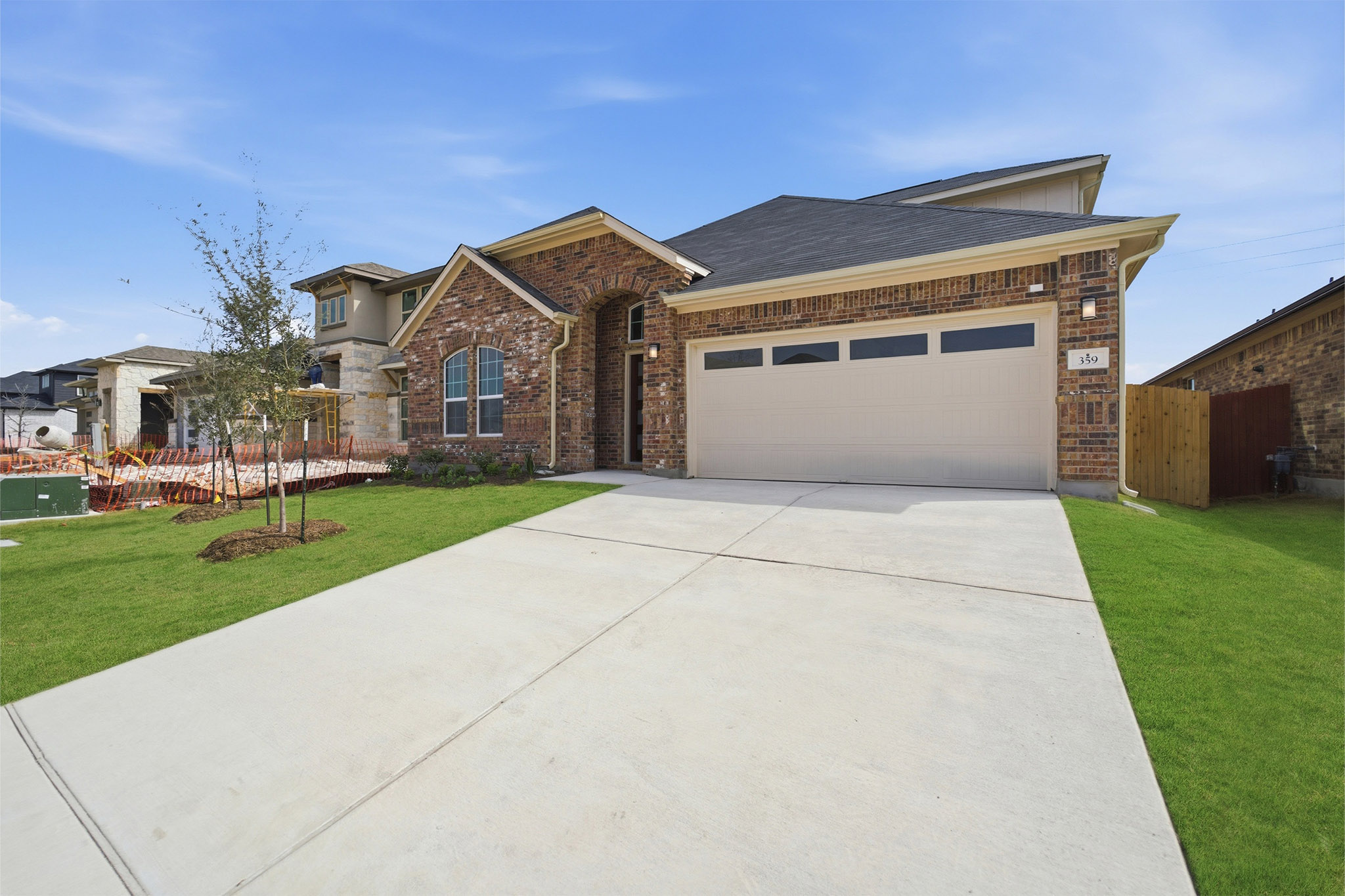 359 Grey Leaf Road Buda, TX 78610 - Photo 3 of 37 View of front facade featuring an attached garage, driveway, and brick siding