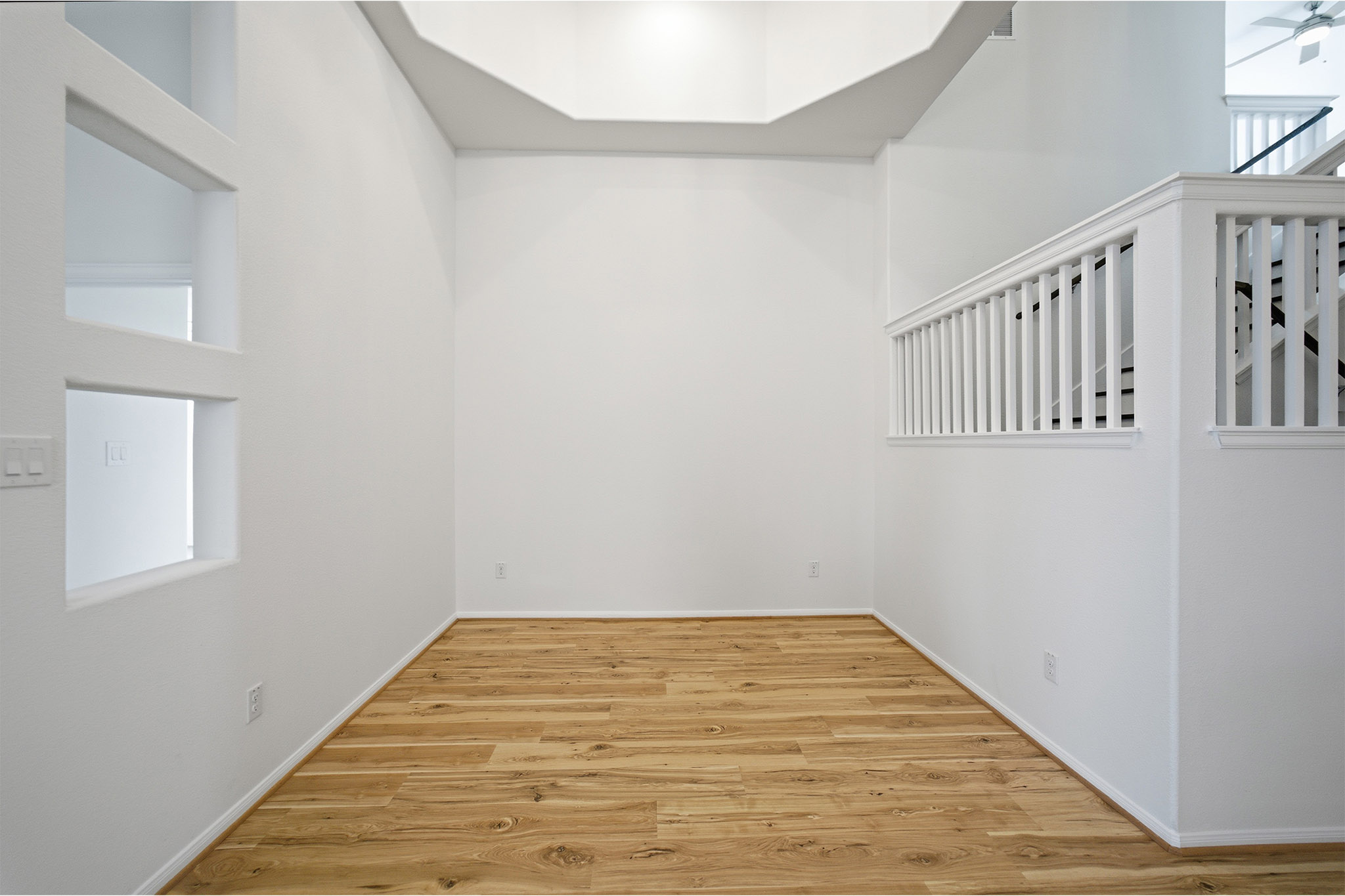 359 Grey Leaf Road Buda, TX 78610 - Photo 32 of 37 Spare room featuring light wood-type flooring, plenty of natural light, a high ceiling, and a ceiling fan