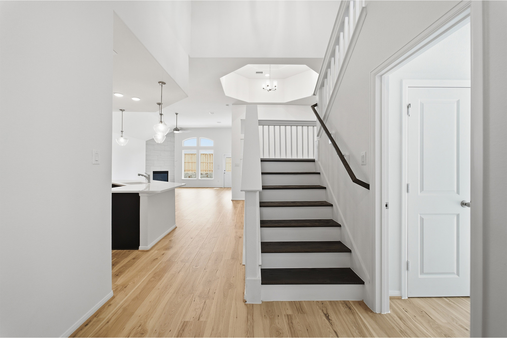 359 Grey Leaf Road Buda, TX 78610 - Photo 33 of 37 Staircase with wood finished floors, a fireplace, and recessed lighting