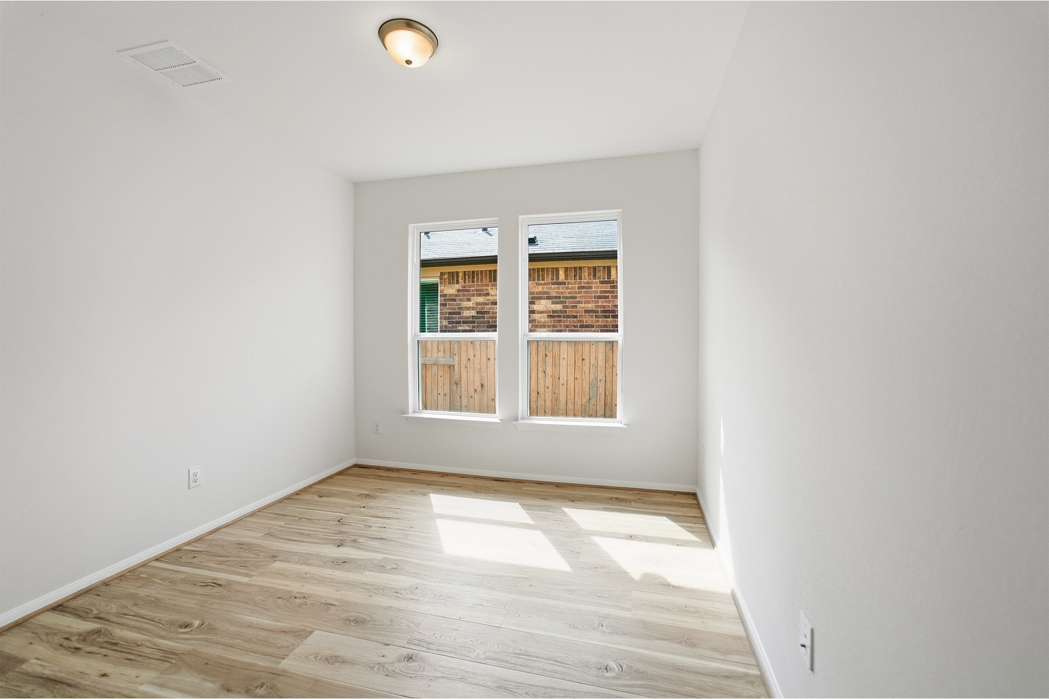 359 Grey Leaf Road Buda, TX 78610 - Photo 34 of 37 Empty room featuring light wood-type flooring and baseboards